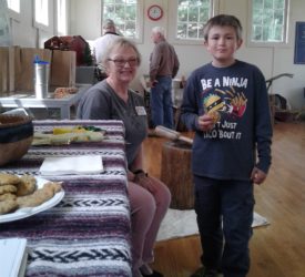 21 April 2018- Angel Mounds, Farm Fest. Denise Lynch and young visitor with squash cookie homemade cookies made from Three Sisters Garden squash.